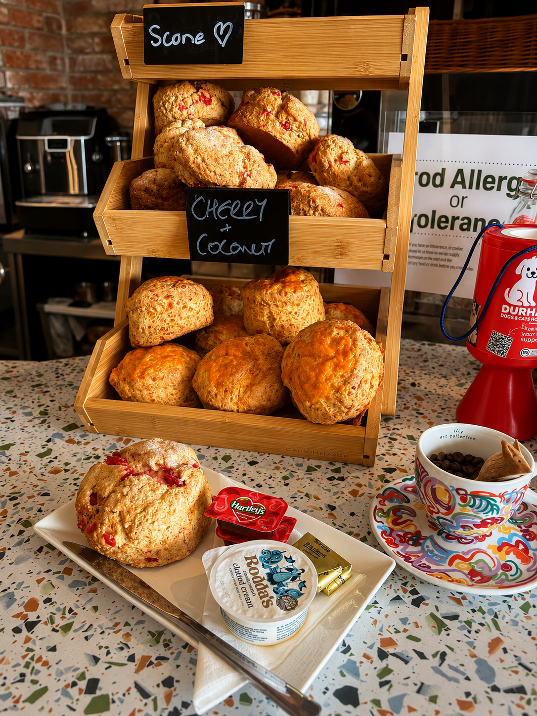 Fresh savoury scones displayed in a wooden stand at Low Tide Coffee House